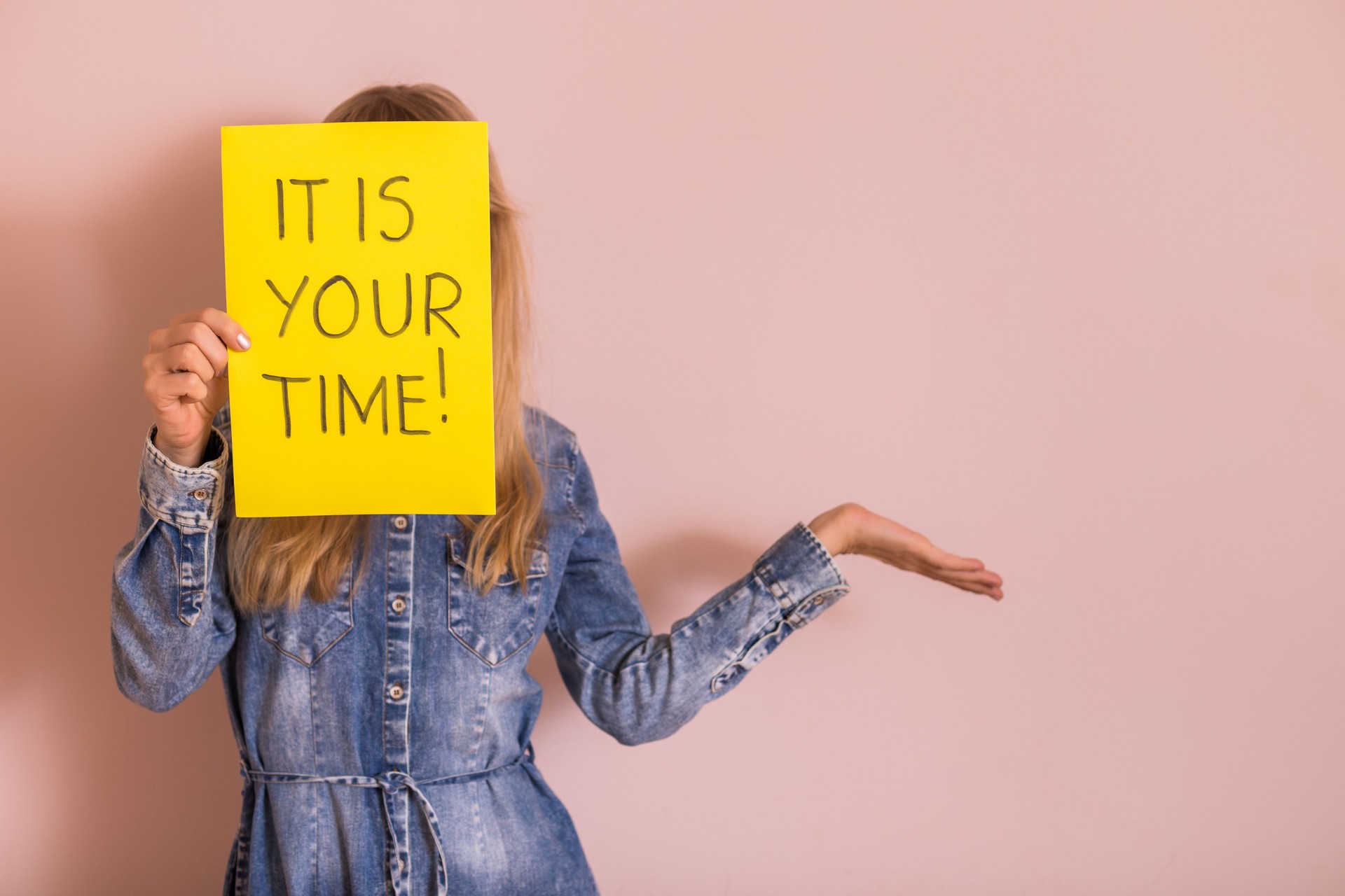 Woman holding paper with text it is your time