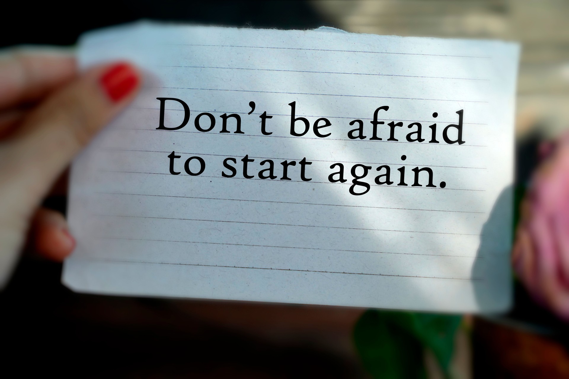 Text message on the thorn paper in hand - Don't be afraid to start again.